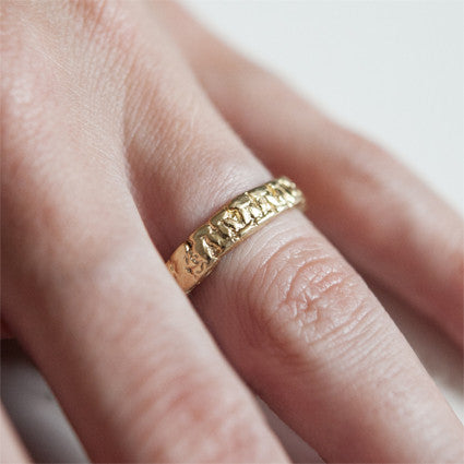 14K Yellow gold textured band on hand