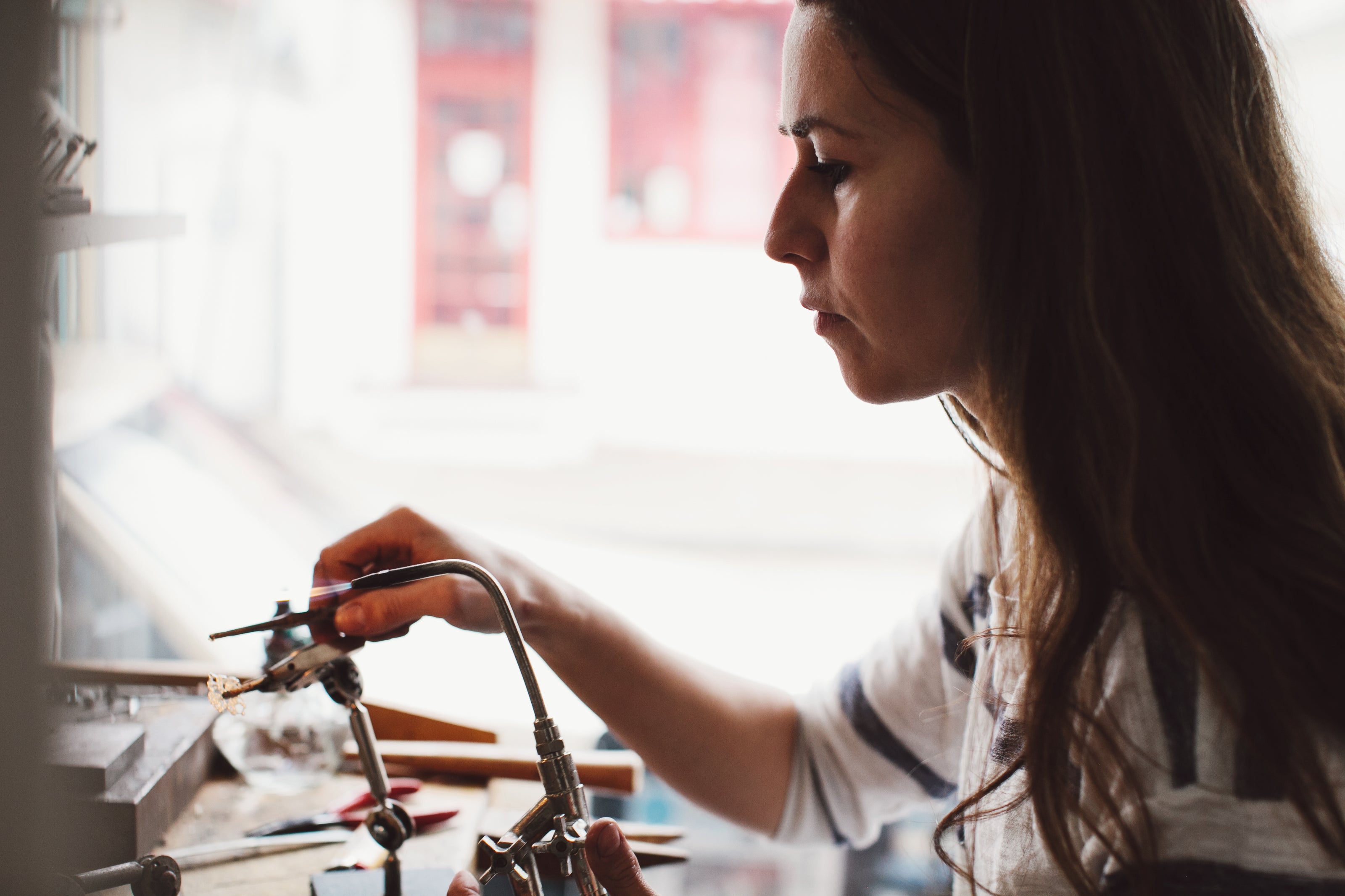 Karin Best soldering jewelry in her studio